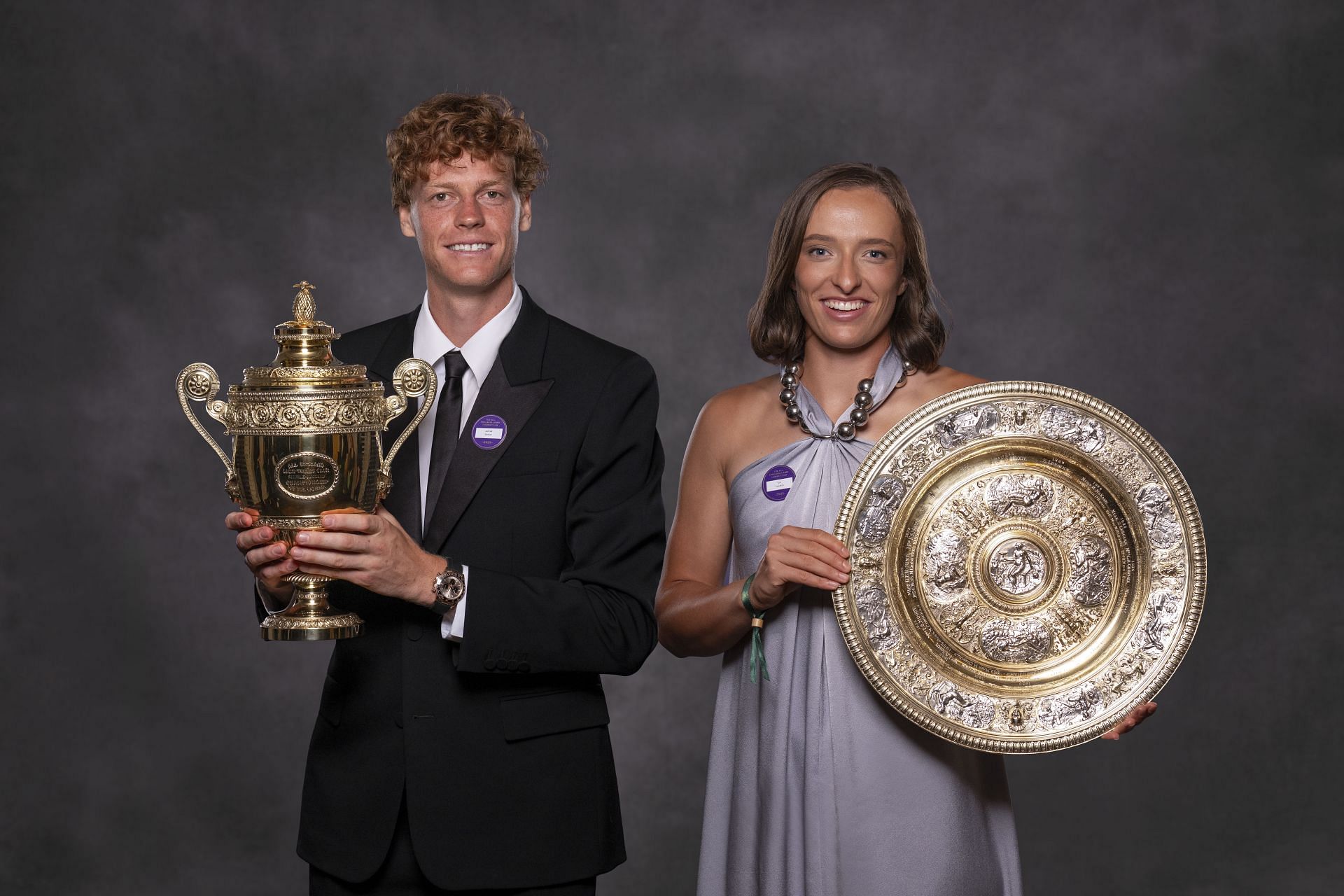 Jannik Sinner (left) and Iga Swiatek (right) with the 2025 Wimbledon Championships' men's and women's singles trophies respectively (Source: Getty)